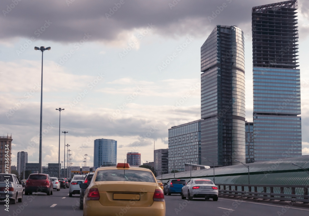 The traffic jam on a city road surrounded by skyscrapers.