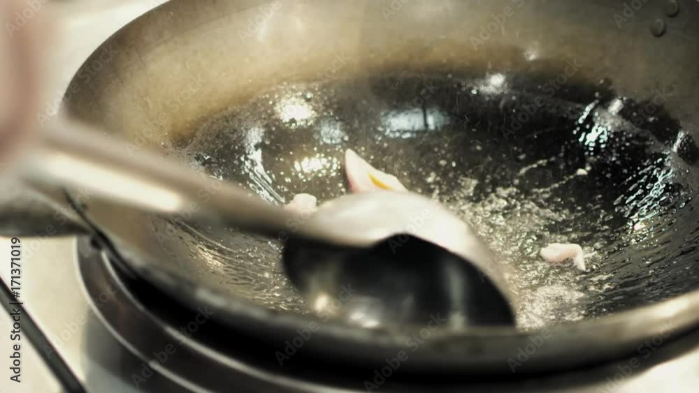 A chef is cooking Chinese Udon noodles with vegetables A chef is cooking Chinese Udon noodles with vegetables