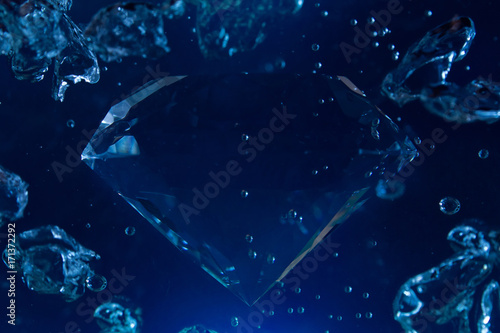 Obraz na plátne Photo of a blue diamond in water with bubbles floating.