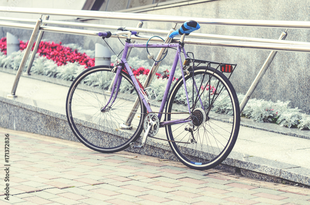 Old road bike of pink color with a 