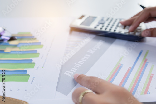 Businessman check profit document and calculate about and note data cost at home ,Finance managers task,Currency investment that think carefully. Concept business and finance photo
