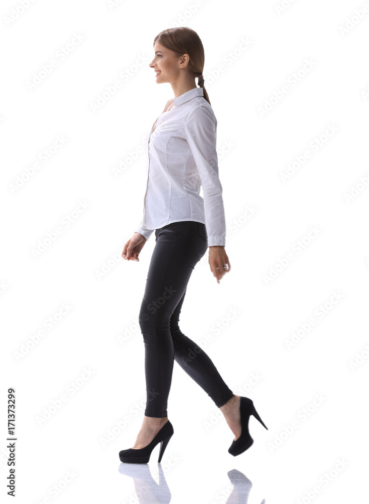 side view.in full growth.confident young woman is moving forward confidently. side view.in full growth.confident young woman is moving forward confidently.