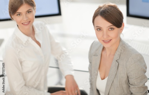 portrait of two business women on the background of the workplace.
