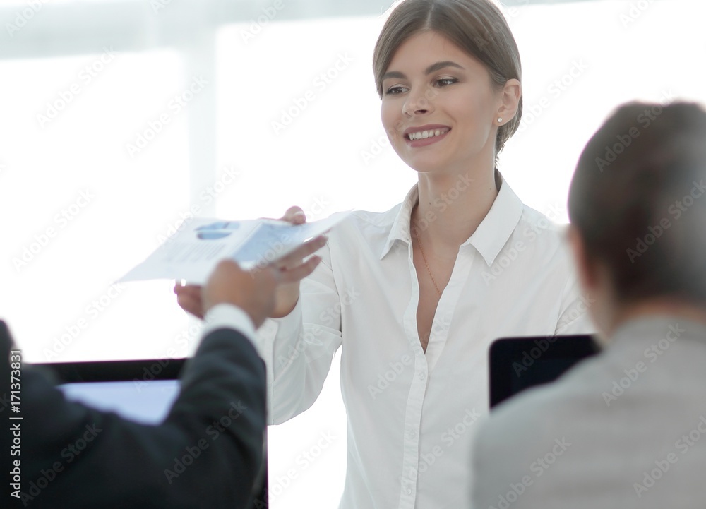 senior Manager, handing the employee a document with financial data. senior Manager, handing the employee a document with financial data.