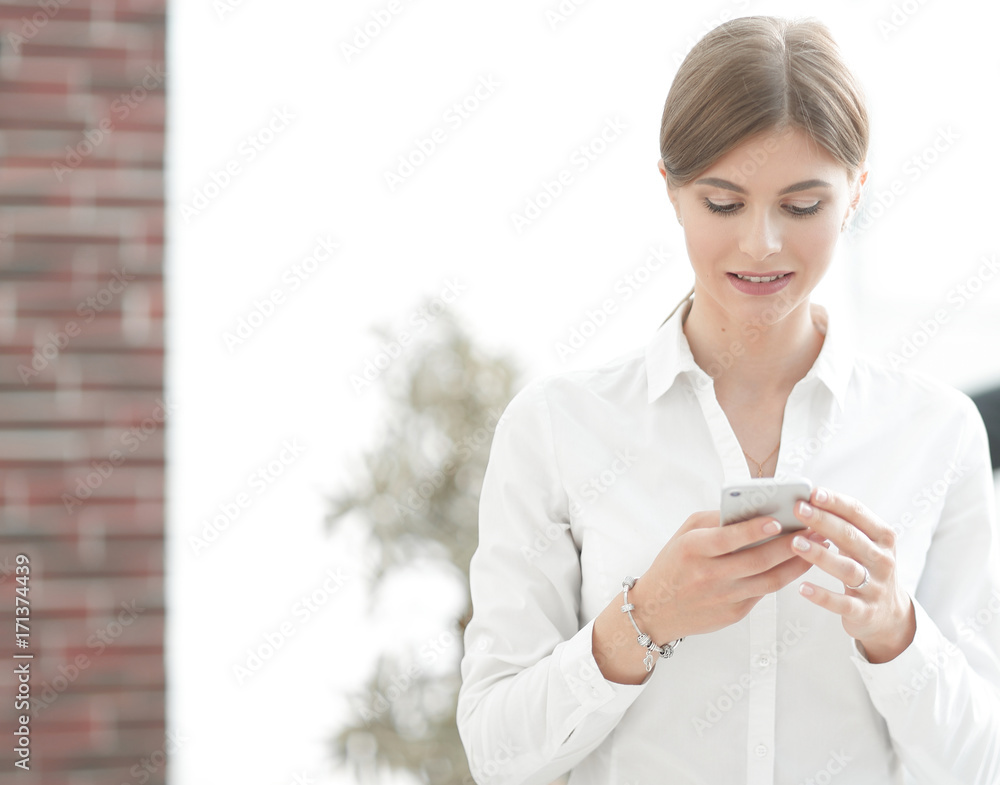 Closeup portrait young, shocked business woman, looking at cell phone Closeup portrait young, shocked business woman, looking at cell phone