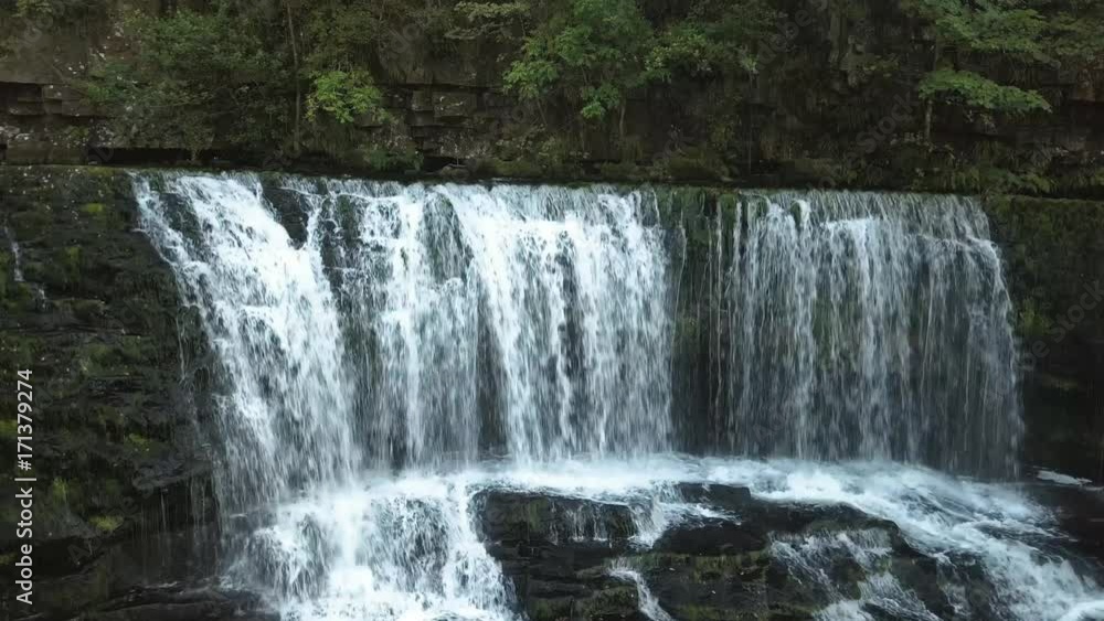 A large waterfall in a narrow canyon A large waterfall in a narrow canyon