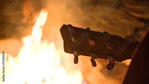 Closeup Guitar Neck Silhouette against Beautiful Bonfire photo