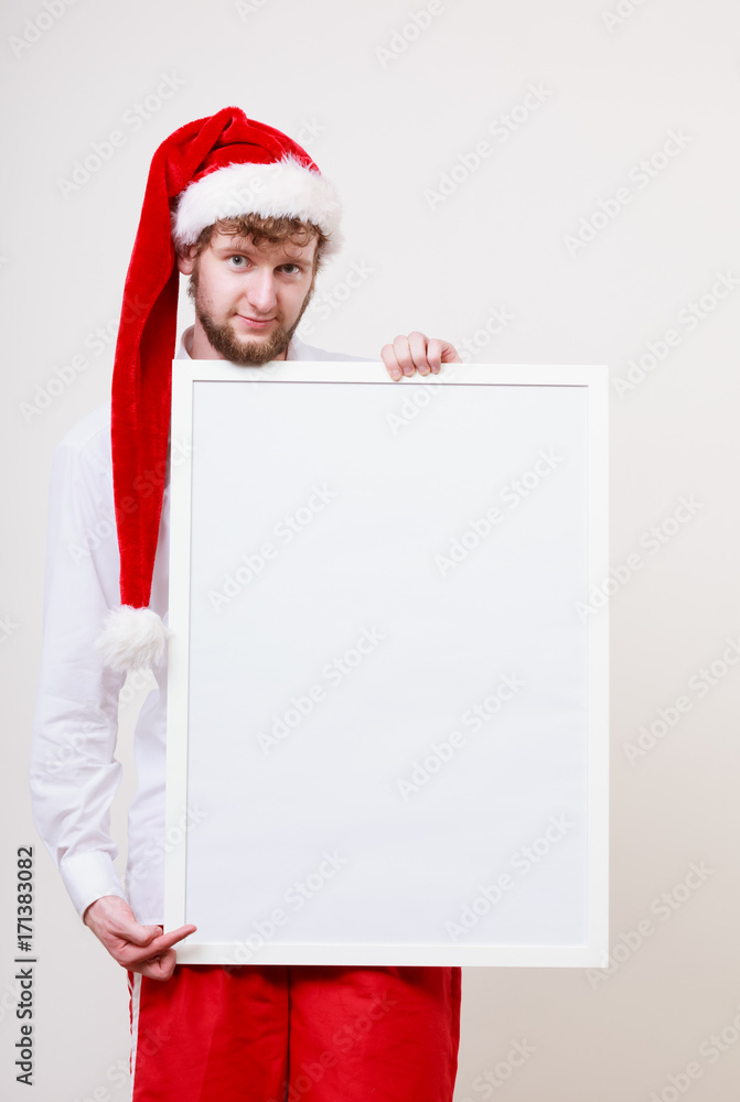 Man in santa hat with blank banner. Copy space. Man in santa hat with blank banner. Copy space.