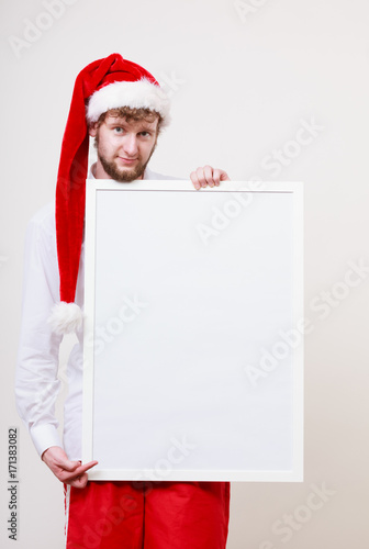 Man in santa hat with blank banner. Copy space. © anetlanda