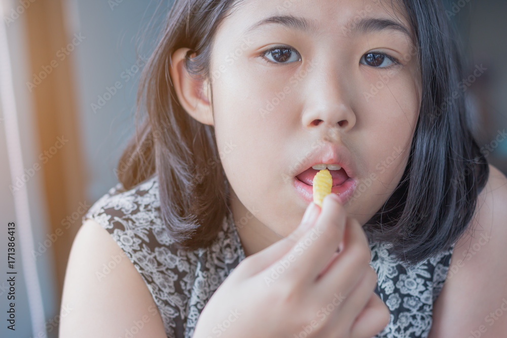 girl action portrait eating French fries girl action portrait eating French fries