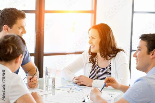 Image of business partners discussing documents and ideas