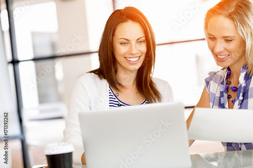 Image of two young business women in office