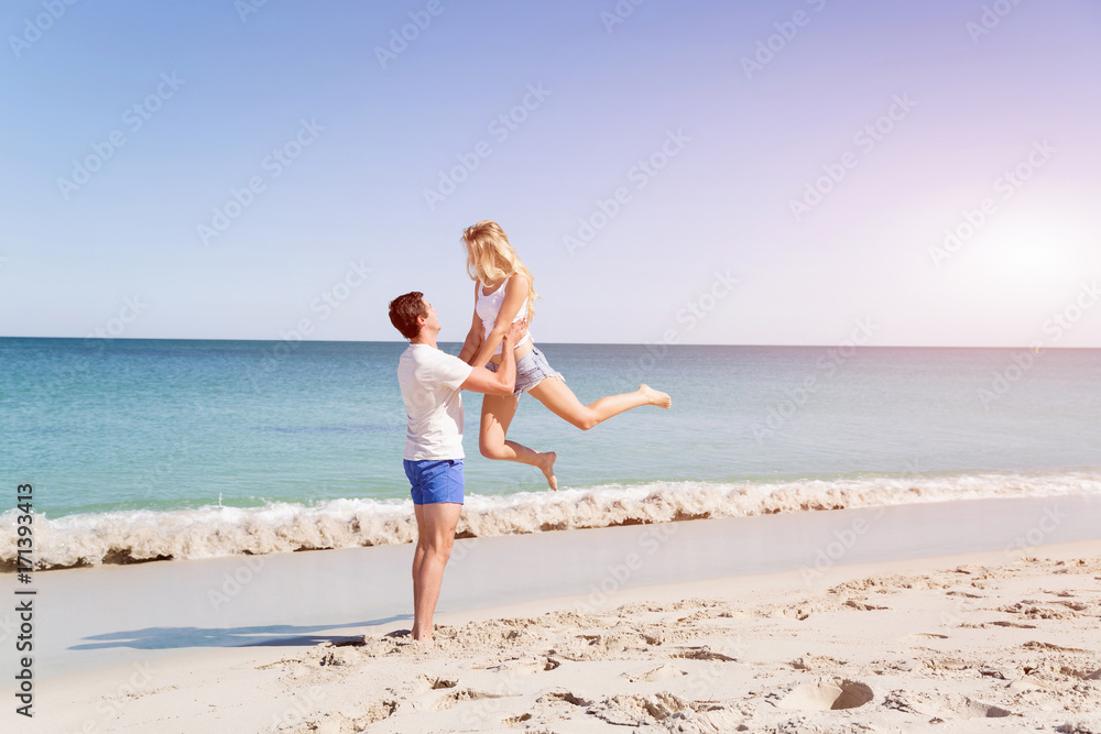 Happy couple jumping on beach vacations Happy couple jumping on beach vacations
