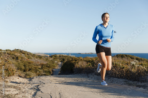Fototapeta Naklejka Na Ścianę i Meble -  Sport runner jogging on beach working out