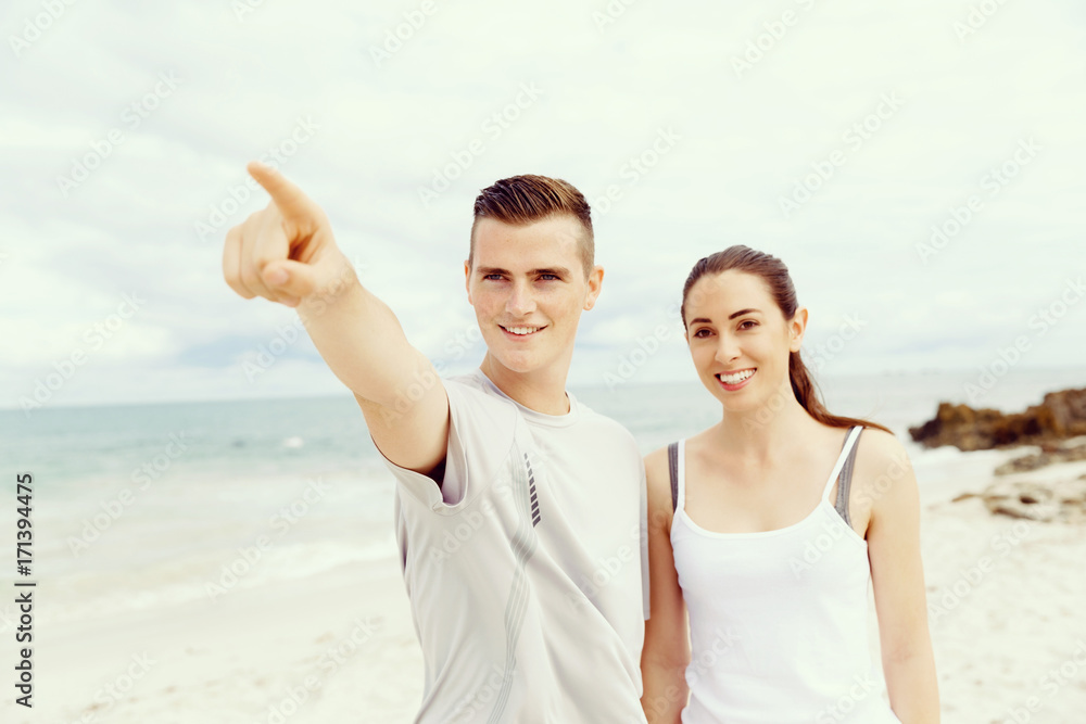 Couple of runners standing together on beach Couple of runners standing together on beach