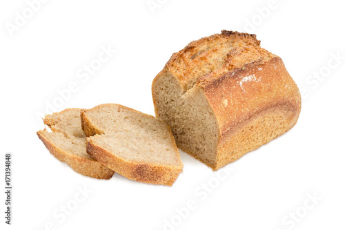 Partially sliced wheat sourdough bread on a white background