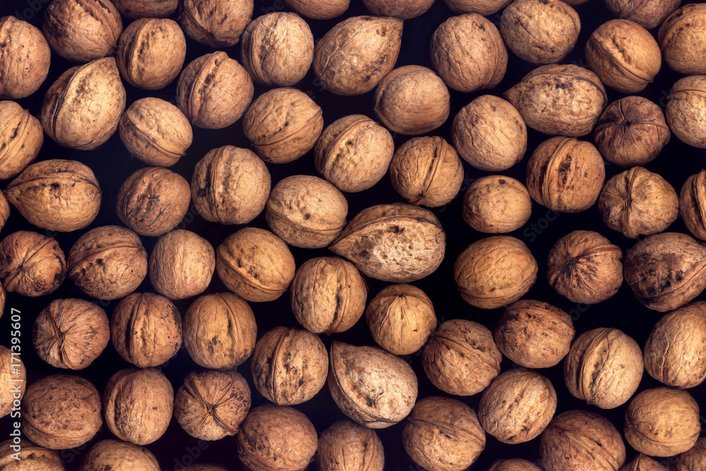 Background of walnuts on a black background Background of walnuts on a black background