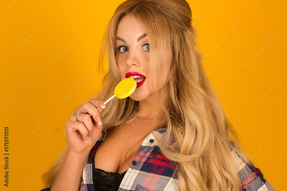 portrait of a beautiful blonde with a lollipop in hands posing portrait of a beautiful blonde with a lollipop in hands posing
