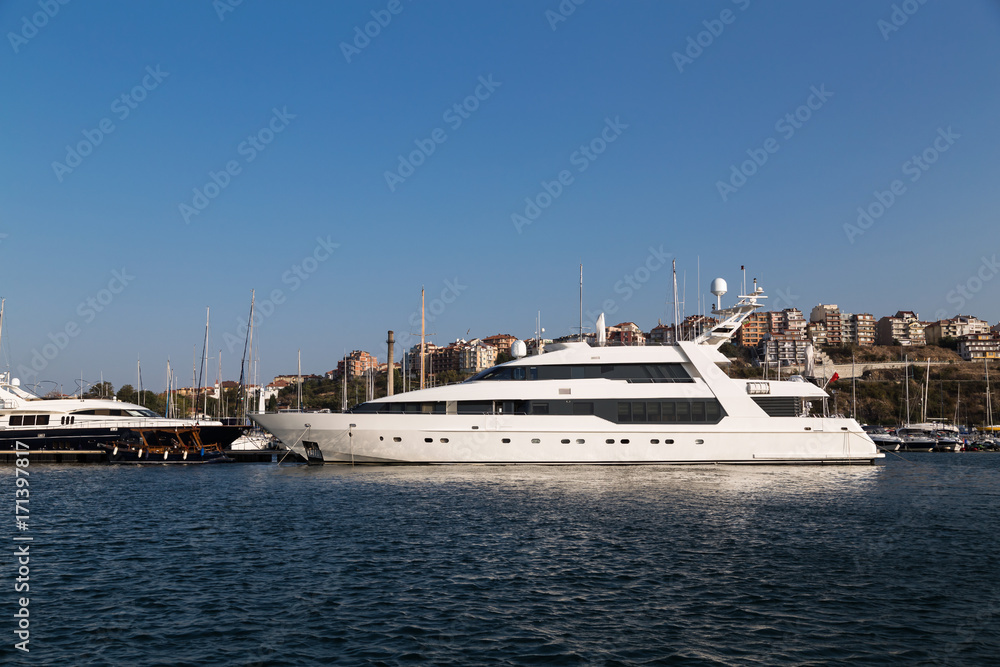 Large luxury white yacht on the port

