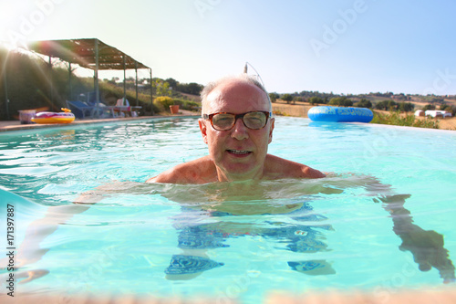 Mature man swimming in pool © tiagozr