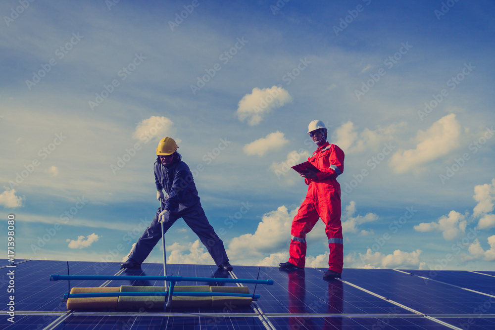 engineer working on checking and maintenance electrical equipment at solar power plant ;engineer checking solar panel in routine operation at solar power plant engineer working on checking and maintenance electrical equipment at solar power plant ;engineer checking solar panel in routine operation at solar power plant