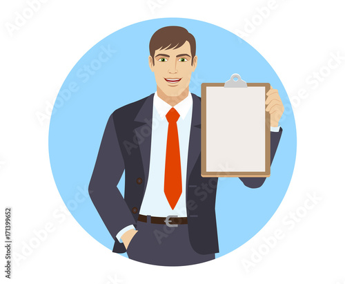 Businessman with hand in pocket holding clipboard