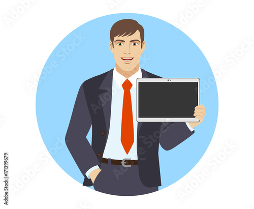 Businessman with hand in pocket showing blank digital tablet PC