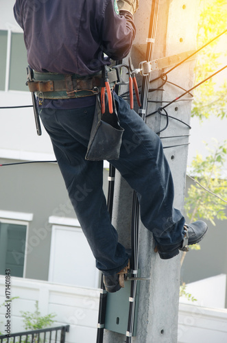 lectrician climbing poles.