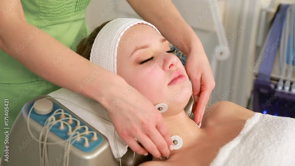 Close up shot of woman at the beautician. Facial electro stimulation. Concept of non-needle hardware cosmetological procedure. Microcurrent therapy on the face with Futura Pro Close up shot of woman at the beautician. Facial electro stimulation. Concept of non-needle hardware cosmetological procedure. Microcurrent therapy on the face with Futura Pro