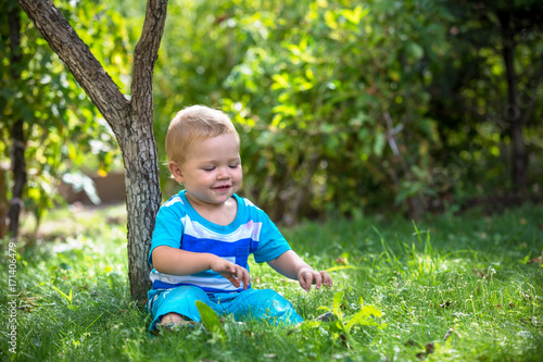 kid on the grass under the tree