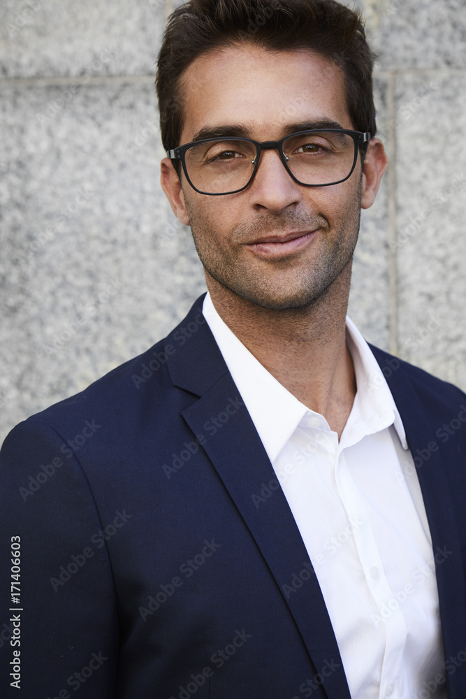 Smiling businessman in suit and glasses, portrait Smiling businessman in suit and glasses, portrait