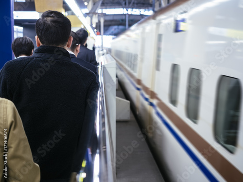 Business people commuters queue on Train platform Japan transportation