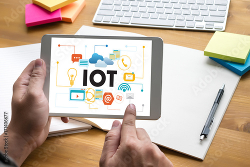 IOT business man hand working and internet of things (IoT) word diagram as concept use Browsing Internet computer Searching Data Internet Marketing