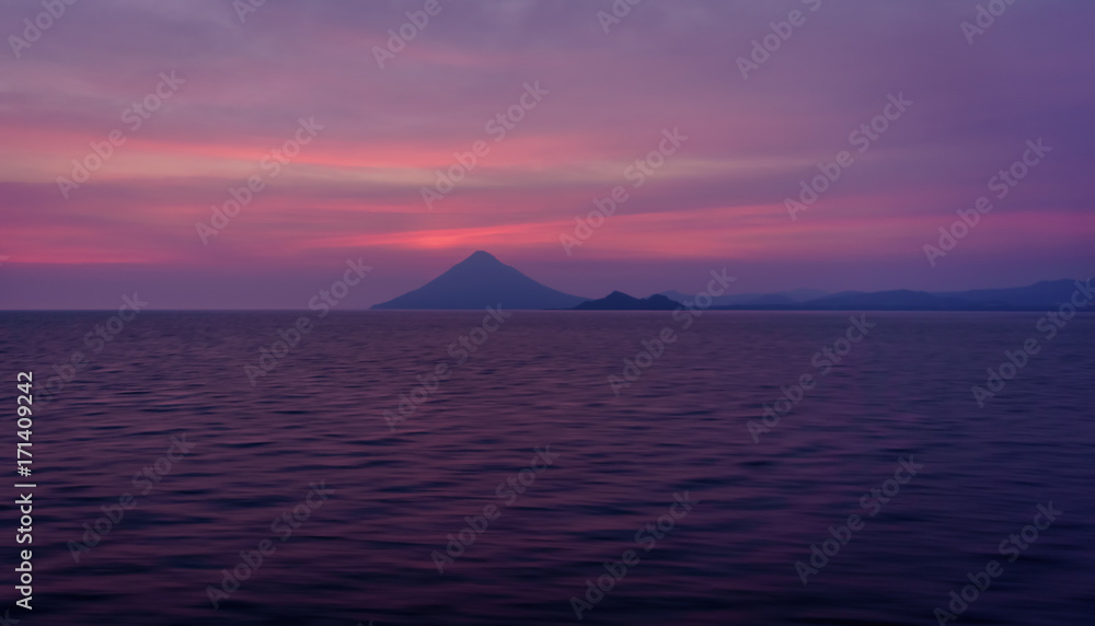 View of volcano from the sea after sunset 