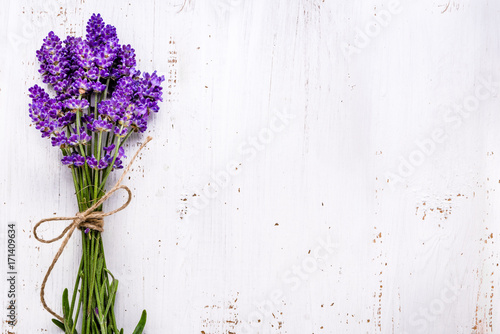 Fototapeta Naklejka Na Ścianę i Meble -  Fresh flowers of lavender bouquet, top view on white wooden background