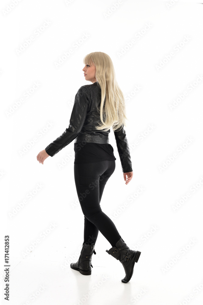 full length portrait of blonde girl wearing black leather outfit, standing pose on white background. full length portrait of blonde girl wearing black leather outfit, standing pose on white background.