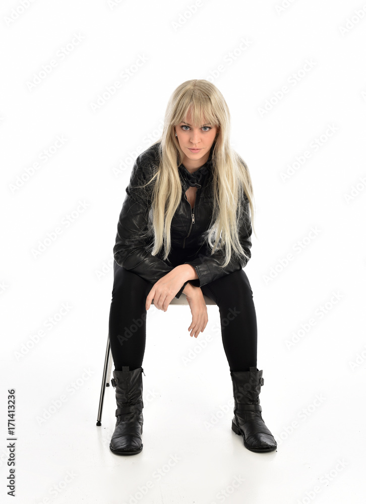 full length portrait of a blonde girl wearing black leather pose, crouching pose on white background. full length portrait of a blonde girl wearing black leather pose, crouching pose on white background.