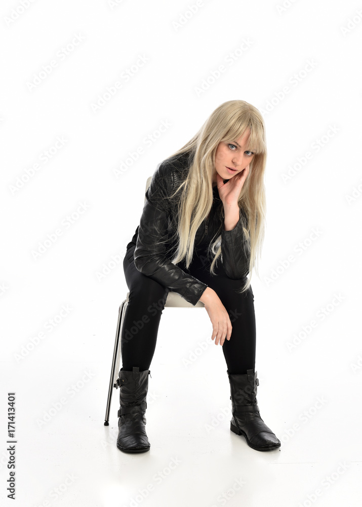 Fototapeta premium full length portrait of a blonde girl wearing black leather pose, crouching pose on white background.