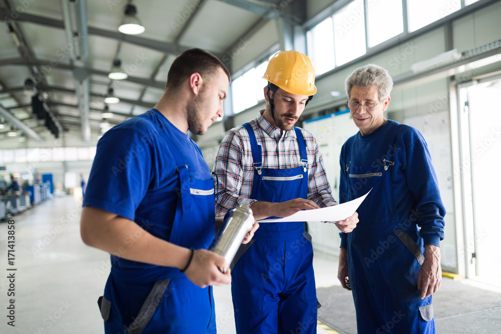 Supplier with engineer checking on production in factory Supplier with engineer checking on production in factory