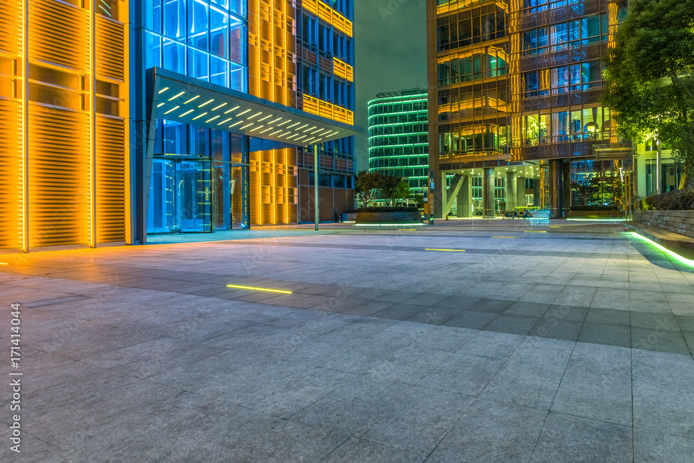 night view of empty brick floor front of urban building night view of empty brick floor front of urban building