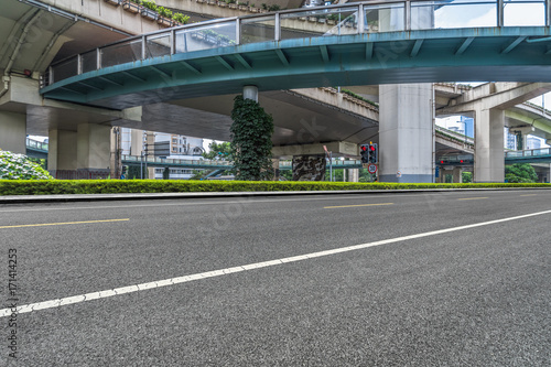 empty asphalt road with city overpass viaduct bridge in shanghai.
