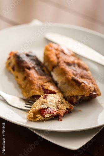 Grilled and fried in eggs paprika with knife and fork on the plate