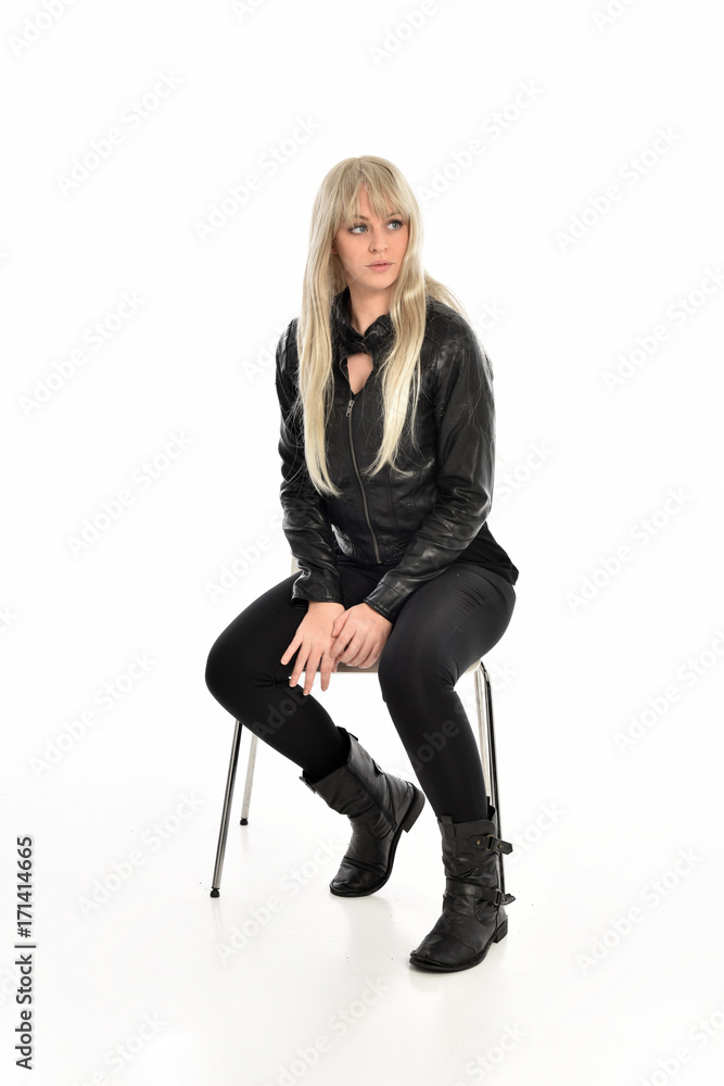 Fototapeta premium full length portrait of a blonde girl wearing black leather pose, crouching pose on white background.