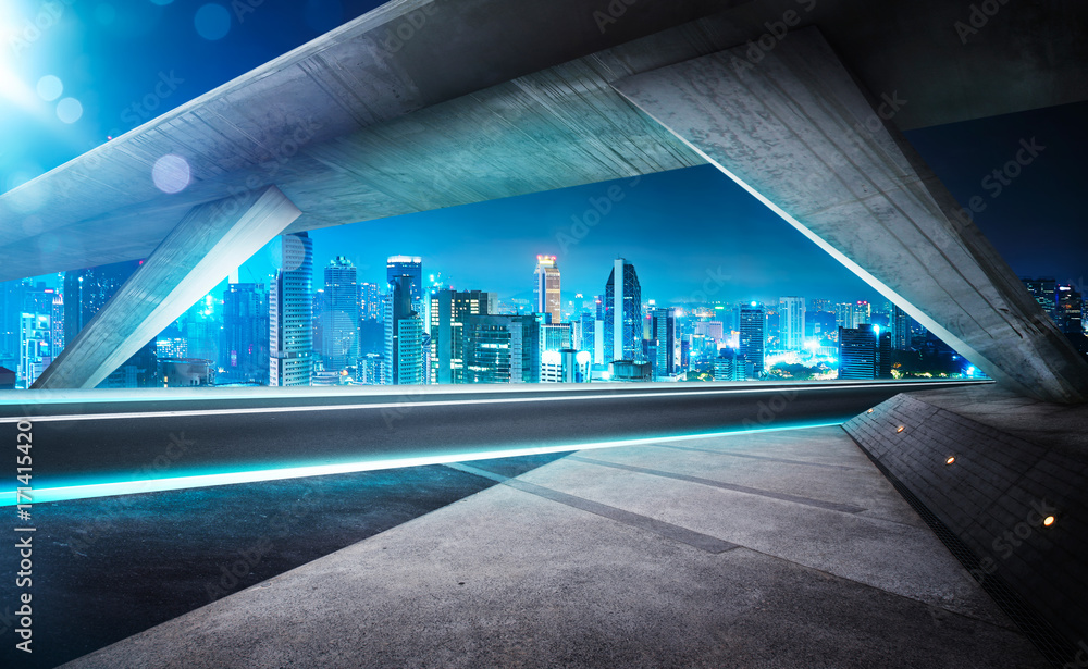 Empty asphalt road under the bridge during the night with beautiful city skyline background . Empty asphalt road under the bridge during the night with beautiful city skyline background .