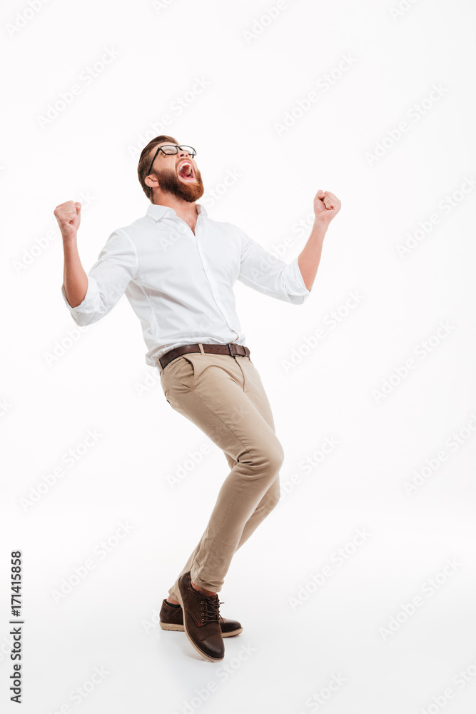Happy young bearded man showing winner gesture. Happy young bearded man showing winner gesture.