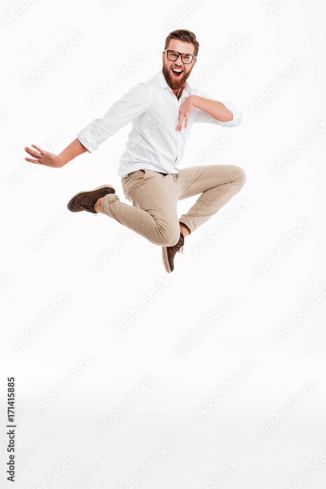 Cheerful young bearded man jumping. Cheerful young bearded man jumping.