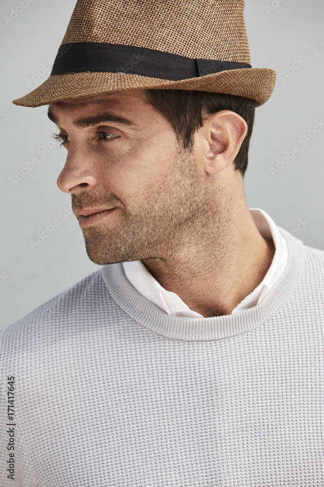 Guy in hat and wearing grey sweater, looking away Guy in hat and wearing grey sweater, looking away