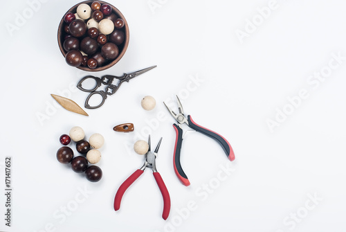 Wooden beads and tools for creating fashion jewelry in the manuf photo