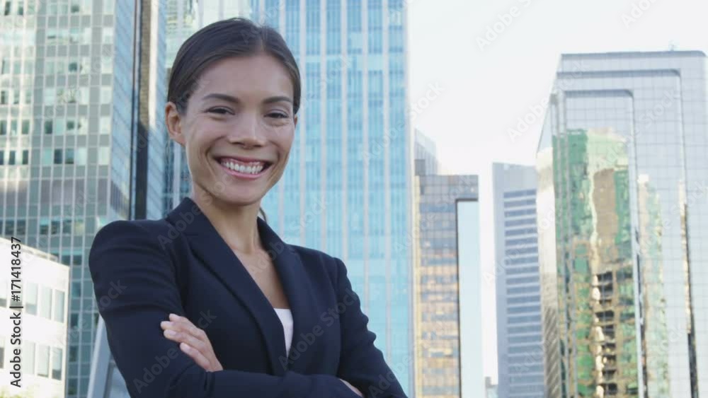 Business woman portrait of young female urban professional businesswoman in suit in city. Business woman portrait of young female urban professional businesswoman in suit in city.