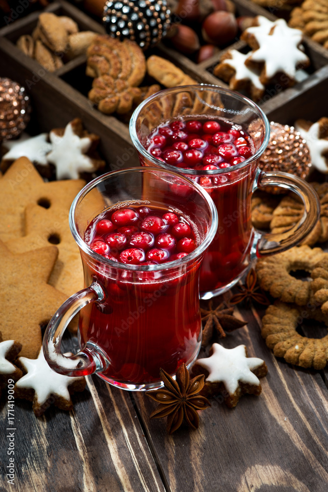 Christmas drink hot cranberry tea and cookies on dark background, vertical Christmas drink hot cranberry tea and cookies on dark background, vertical